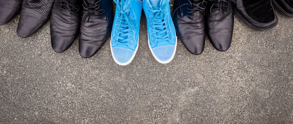 Blue sneakers on asphalt — Stock Photo, Image