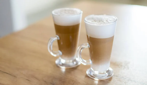 Home made coffee Cafe Macchiato on wooden table.