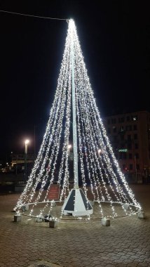 Genova, Italy - December 25, 2021: Beautiful christmas decorations around the city of Genova. Led lights through the streets. Old Architecture.