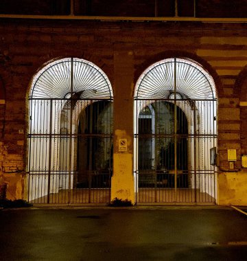 Genova, Italy - December 25, 2021: Beautiful christmas decorations around the city of Genova. Led lights through the streets. Old Architecture.