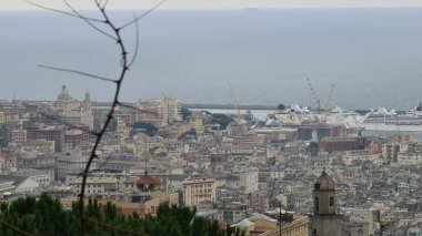 Genova, Italy - January 06, 2022: Aerial view to the port of Genova. Beautiful photographyof the tall skylines of the city. Winter gray clouds and cold weather.