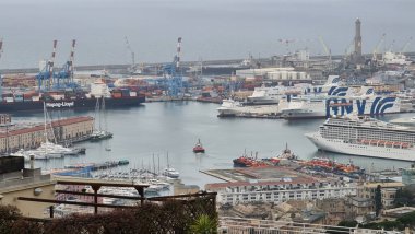 Genova, Italy - January 06, 2022: Aerial view to the port of Genova. Beautiful photographyof the tall skylines of the city. Winter gray clouds and cold weather.
