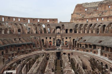 ROME, ITALY - 05 Şubat 2022: Roma, İtalya 'da Colosseum' un iç kısmının panoramik görüntüsü. Arka planda soğuk ve gri gökyüzü. Kemerlerin makro fotoğrafları.
