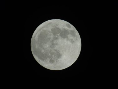 Genova, Italy -May 15, 2022: An amazing photography of the full moon over the city of Genova by night with a great clear sky in background and some stars