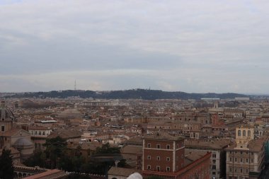 ROME, ITALY - 05 Şubat 2022: Roma, İtalya 'daki Colosseum çevresindeki panoramik manzara. Arka planda soğuk ve gri gökyüzü. Eski binalarla yeşil parkların makro fotoğrafları..