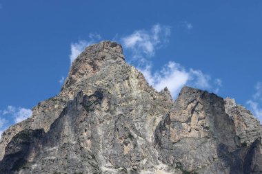 Coravara, Italy-July 16, 2022: The italian Dolomites behind the small village of Corvara in summer days with beaitiful blue sky in the background. Green nature in the middle of the rocks. 
