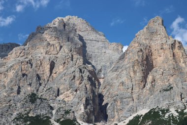 Coravara, Italy-July 16, 2022: The italian Dolomites behind the small village of Corvara in summer days with beaitiful blue sky in the background. Green nature in the middle of the rocks. 