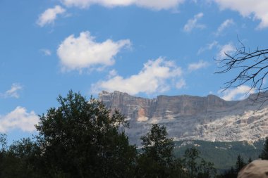 Coravara, Italy-July 16, 2022: The italian Dolomites behind the small village of Corvara in summer days with beaitiful blue sky in the background. Green nature in the middle of the rocks. 