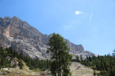 Val Badia, Italy-July 17, 2022: The italian Dolomites behind the small village of Corvara in summer days with beaitiful blue sky in the background. Green nature in the middle of the rocks.