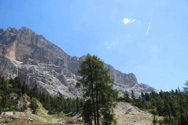 Val Badia, Italy-July 17, 2022: The italian Dolomites behind the small village of Corvara in summer days with beaitiful blue sky in the background. Green nature in the middle of the rocks.