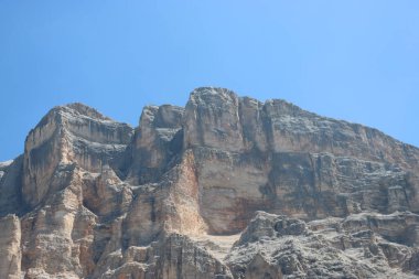 Val Badia, Italy-July 17, 2022: The italian Dolomites behind the small village of Corvara in summer days with beaitiful blue sky in the background. Green nature in the middle of the rocks.