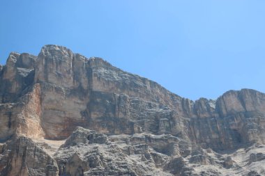 Val Badia, Italy-July 17, 2022: The italian Dolomites behind the small village of Corvara in summer days with beaitiful blue sky in the background. Green nature in the middle of the rocks.