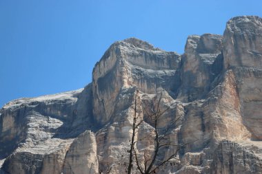 Val Badia, Italy-July 17, 2022: The italian Dolomites behind the small village of Corvara in summer days with beaitiful blue sky in the background. Green nature in the middle of the rocks.