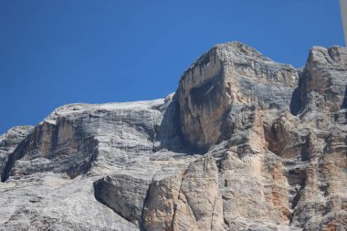 Val Badia, Italy-July 17, 2022: The italian Dolomites behind the small village of Corvara in summer days with beaitiful blue sky in the background. Green nature in the middle of the rocks.