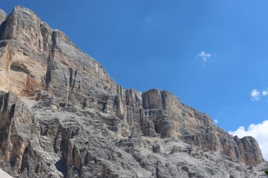 Val Badia, Italy-July 17, 2022: The italian Dolomites behind the small village of Corvara in summer days with beaitiful blue sky in the background. Green nature in the middle of the rocks.