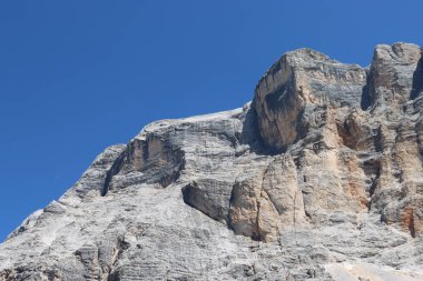 Val Badia, Italy-July 17, 2022: The italian Dolomites behind the small village of Corvara in summer days with beaitiful blue sky in the background. Green nature in the middle of the rocks.