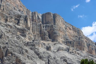 Val Badia, Italy-July 17, 2022: The italian Dolomites behind the small village of Corvara in summer days with beaitiful blue sky in the background. Green nature in the middle of the rocks.