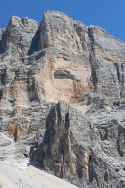 Val Badia, Italy-July 17, 2022: The italian Dolomites behind the small village of Corvara in summer days with beaitiful blue sky in the background. Green nature in the middle of the rocks.