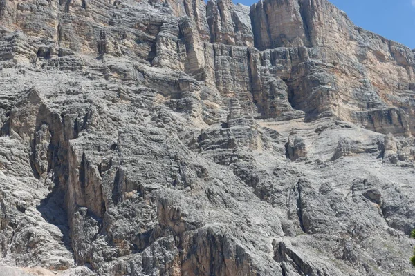 Val Badia, Italy-July 17, 2022: The italian Dolomites behind the small village of Corvara in summer days with beaitiful blue sky in the background. Green nature in the middle of the rocks.