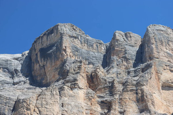 Val Badia, Italy-July 17, 2022: The italian Dolomites behind the small village of Corvara in summer days with beaitiful blue sky in the background. Green nature in the middle of the rocks.