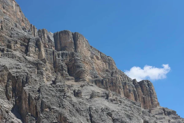 Val Badia, Italy-July 17, 2022: The italian Dolomites behind the small village of Corvara in summer days with beaitiful blue sky in the background. Green nature in the middle of the rocks.