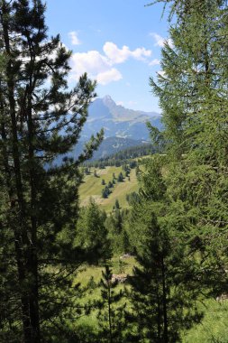 Val Badia, Italy-July 17, 2022: The italian Dolomites behind the small village of Corvara in summer days with beaitiful blue sky in the background. Green nature in the middle of the rocks.