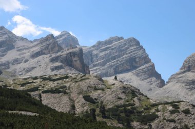 Val Badia, Italy-July 18, 2022: The italian Dolomites behind the small village of Corvara in summer days with beaitiful blue sky in the background. Green nature in the middle of the rocks.