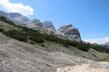 Val Badia, Italy-July 18, 2022: The italian Dolomites behind the small village of Corvara in summer days with beaitiful blue sky in the background. Green nature in the middle of the rocks.