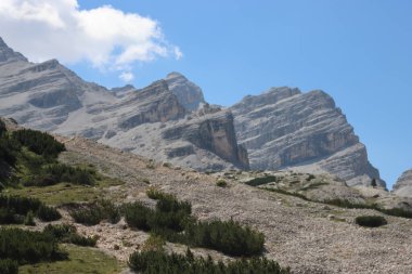 Val Badia, Italy-July 18, 2022: The italian Dolomites behind the small village of Corvara in summer days with beaitiful blue sky in the background. Green nature in the middle of the rocks.