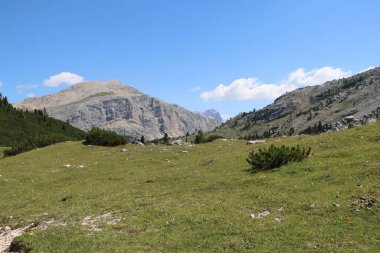 Val Badia, Italy-July 18, 2022: The italian Dolomites behind the small village of Corvara in summer days with beaitiful blue sky in the background. Green nature in the middle of the rocks.