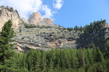 Val Badia, Italy-July 18, 2022: The italian Dolomites behind the small village of Corvara in summer days with beaitiful blue sky in the background. Green nature in the middle of the rocks.