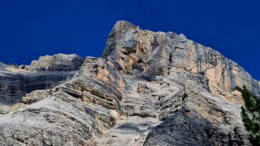 Val Badia, Italy-July 18, 2022: The italian Dolomites behind the small village of Corvara in summer days with beaitiful blue sky in the background. Green nature in the middle of the rocks.