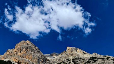 Val Badia, Italy-July 18, 2022: The italian Dolomites behind the small village of Corvara in summer days with beaitiful blue sky in the background. Green nature in the middle of the rocks.