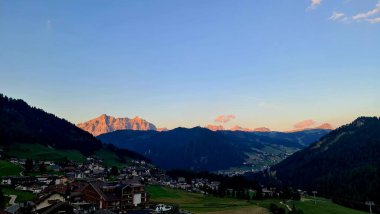 Val Badia, Italy-July 18, 2022: The italian Dolomites behind the small village of Corvara in summer days with beaitiful blue sky in the background. Green nature in the middle of the rocks.