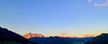 Val Badia, Italy-July 18, 2022: The italian Dolomites behind the small village of Corvara in summer days with beaitiful blue sky in the background. Green nature in the middle of the rocks.