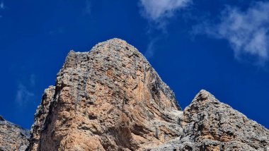 Val Badia, Italy-July 18, 2022: The italian Dolomites behind the small village of Corvara in summer days with beaitiful blue sky in the background. Green nature in the middle of the rocks.