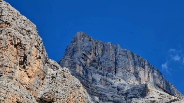 Val Badia, Italy-July 18, 2022: The italian Dolomites behind the small village of Corvara in summer days with beaitiful blue sky in the background. Green nature in the middle of the rocks.