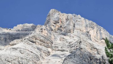 Val Badia, Italy-July 18, 2022: The italian Dolomites behind the small village of Corvara in summer days with beaitiful blue sky in the background. Green nature in the middle of the rocks.