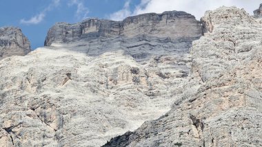 Val Badia, Italy-July 18, 2022: The italian Dolomites behind the small village of Corvara in summer days with beaitiful blue sky in the background. Green nature in the middle of the rocks.