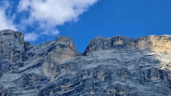 Val Badia, Italy-July 18, 2022: The italian Dolomites behind the small village of Corvara in summer days with beaitiful blue sky in the background. Green nature in the middle of the rocks.