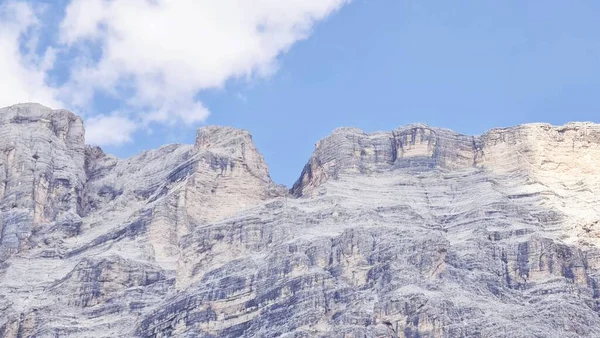 Val Badia, Italy-July 18, 2022: The italian Dolomites behind the small village of Corvara in summer days with beaitiful blue sky in the background. Green nature in the middle of the rocks.