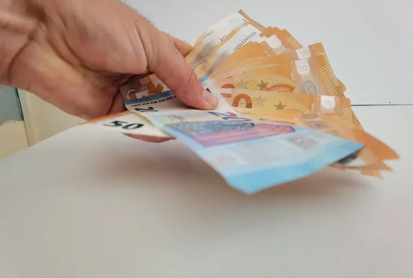 Hand Gibt Geld Euros Stapeln Banknoten Weißem Hintergrund — Stockfoto