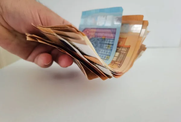 Hand Gives Money Euros Pile Banknotes White Background — Photo