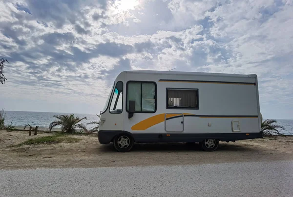 caravan car by the sea in spring season clouds and sun in the sky holidays travel