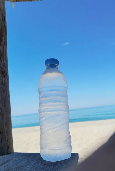 water bottle by the sea in summer holidays  sun beach
