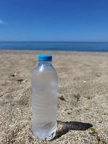water bottle by the sea in summer holidays  sun beach