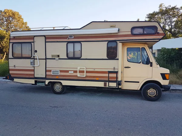 caravan car retro big long brown colors,  on the road in summer