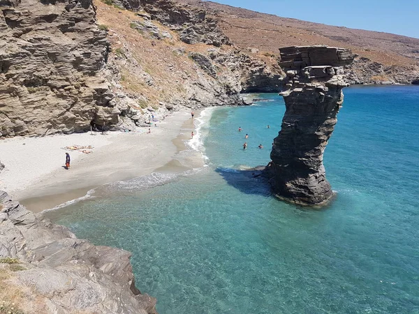 greece andros island beach called tis grias to pidima, rock high in the sea in summer season