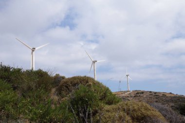 wind-energy park wind generators blue sky and clouds  in andros island greece