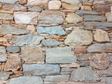 wall of natural rocks in andros island greece 
